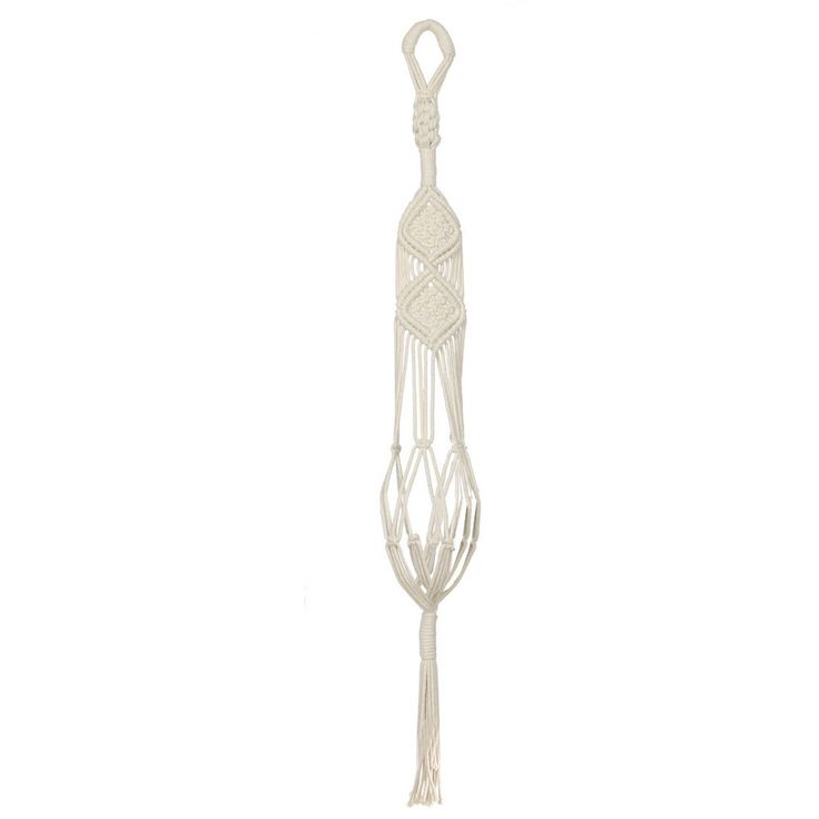 a white kitchen utensil hanging from a hook on a wall in front of a white background