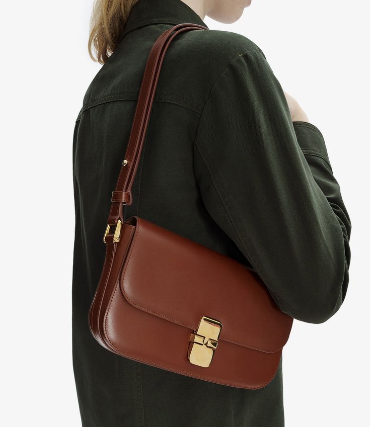 A.P.C. Women's bag. - Adjustable leather shoulder strap.- Can be worn on the shoulder or across the chest.- Goldtone hardware clasp.- One interior pocket.- Embossed goldtone 'A.P.C. Rue Madame Paris' logo.