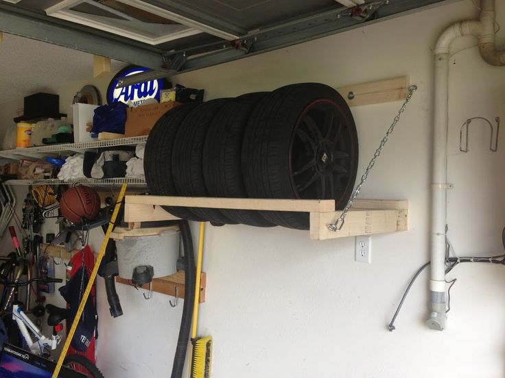 a garage filled with lots of different types of tools and equipment, including a car tire