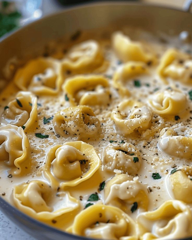 a pan filled with pasta and sauce on top of a table