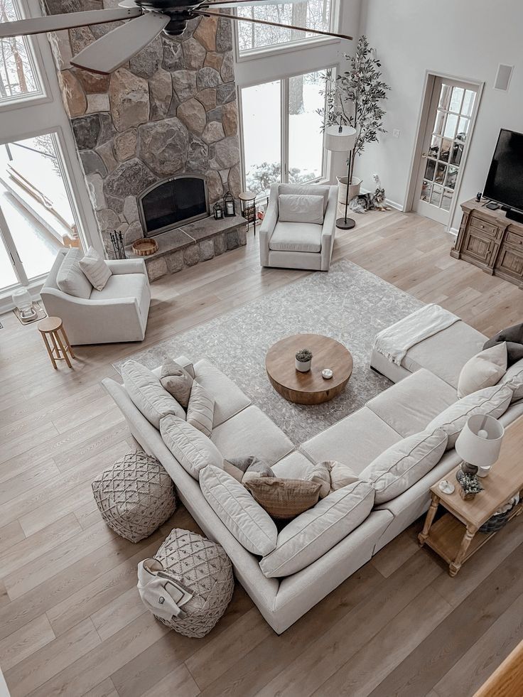 an aerial view of a living room with white furniture