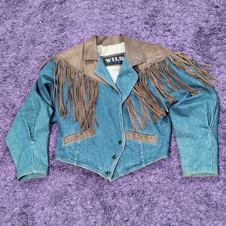 Very Good Condition. The Denim And Leather Have A Fabulous Look. Please View Pictures For Condition And Measurements. Please View Measurement Size Pictures For Size Accuracy. Some Browning Inside Cuffs, And Neck Collar Area Please View Pictures. One Leather Fringe Is Smaller Than Other Fringe. Missing One Of The Metal Parts For Tying The Fringe. Minor Issues Jrj Coats Vintage, The Fringe, View Pictures, Vintage Jackets, Leather Fringe, Vintage Jacket, Moto Jacket, Neck Collar, Browning