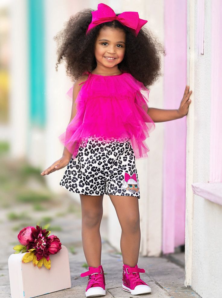 This Diva is ready for spring fashion with our L.O.L. SURPRISE!™ Diva shorts set. The three-tiered top in vibrant fuchsia top with satin cheetah print shorts gives the perfect balance of sass and style. And the signature cheetah print shorts featuring Diva's adorable face complete the look. How fabulous! Breathable flowy fabric means no itching, tugging, or fussing with her clothes This unique collaboration brings one-of-a-kind fashion to little girls everywhere! Don't miss out on couture clothing for your cutie. Perfect for family outings, birthday parties, photoshoots, pageants, and more Fuchsia tiered ruffle top with adjustable shoulder straps and L.O.L. SURPRISE!™ Diva embroidered black-and-white satin cheetah print shorts Set available in sizes 2T/3T-10Y/12Y for toddlers and girls Toddler Flower Girls, Girls Gloves, Girls Dress Outfits, Family Outings, Toddler Flower Girl Dresses, Infant Flower Girl Dress, Tea Party Dress, Christening Outfit