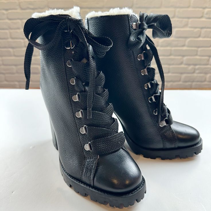 Elevate Your Winter Style With These Boots By Schutz In The Zhara Style. Plush Faux Fur Lines A Towering Lace-Up Boot Grounded By A Block Heel And Chunky Lugged Sole. Pebbled Leather And Oversized Ribbon Like Laces Add A Feminine Touch. These Boots Are New And Never Used. No Box. Color: Black Size: 7 4 1/4" Heel 5" Shaft Leather Upper/Textile Faux-Fur Lining/Rubber Sole Perfect To Pair With Jeans, Leggings Or Dresses During Cold Weather Months. Black High Heel Lace-up Boots For Winter, Winter Heeled Boots With Reinforced Heel, Winter Heeled Boots With Padded Ankle, Winter Black Lace-up Boots With Reinforced Heel, Black Lace-up Boots With Reinforced Heel For Winter, Winter Platform Lace-up Booties, Winter Platform Wedge Boots In Faux Leather, Winter Lace-up Boots With Lug Sole And Closed Toe, Winter Moto Boots With Synthetic Material And Round Toe