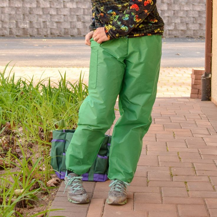 "Outdoor exploration on wet days can be a challenge, but these simple, functional pants will keep you dry, whatever the weather. Designed to be pulled on over clothing, they have plenty of ease for hiking, kneeling in the garden, or puddle splashing with little ones. Combine optional features such as elastic stirrups, pockets, and knee and seat patches to make the perfect rain pants! A seam-sealing tutorial is included for a truly waterproof finish. * The entire Rainhaven Collection is available Green Outdoor Pants With Elastic Waistband, Green Sporty Pants For Outdoor Activities, Sporty Green Pants For Outdoor Activities, Green Nylon Hiking Pants, Green Sporty Parachute Pants For Outdoor Activities, Green Outdoor Bottoms With Elastic Waistband, Sporty Green Parachute Pants For Outdoor Activities, Green Bottoms With Elastic Waistband For Outdoor, Green Casual Cargo Pants For Outdoor Work