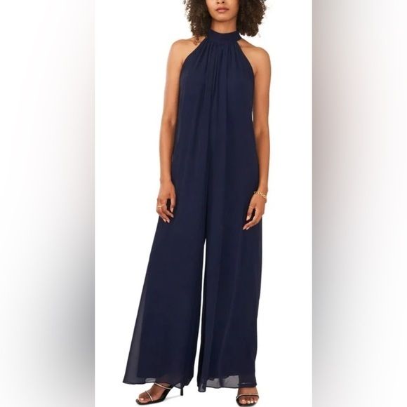 Vince Camuto Womens Navy Lined Zippered Sheer Tie Back Sleeveless Halter Wide Leg Jumpsuit. Navy Blue Size Small Elegant Strapless Jumpsuit For Beach, Summer Workwear Halter Neck Jumpsuit, Summer Workwear Halter Neck Jumpsuits And Rompers, Blue Casual Evening Jumpsuits And Rompers, Elegant Sleeveless Strapless Jumpsuit For Beach, Chic Blue Sleeveless Jumpsuits And Rompers, Casual Blue Jumpsuits And Rompers For Evening, Elegant Blue Strapless Jumpsuit, Elegant Blue Sleeveless Jumpsuits And Rompers