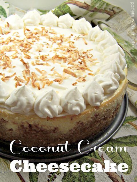 a cheesecake topped with whipped cream and toasted almonds