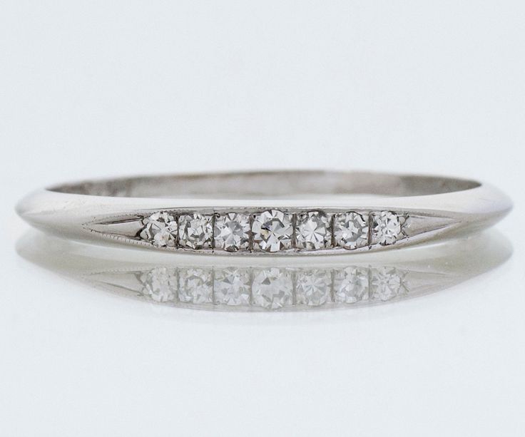 "Here in rich, strong platinum we have a classic antique diamond band. Seven shimmering diamonds sit prettily across the face of this petite band. A bonus is that it is engraved, and we love that in our shop because it allows us to dream of a wonderful romance of long ago. Pair it with your modern or antique engagement ring or wear it on it's own. Antique Wedding Band - Antique Platinum Diamond Wedding Band Platinum 7 Diamonds =.11ct VS/G-H Engraved \"P.H.F. to A.G.? 9.3.31\" Ring Size 8.75 (rin Formal Diamond Eternity Band With Single Diamond, Anniversary Diamond Band With Single Diamond, Single Diamond Anniversary Bands, Anniversary Bands With Single Diamond, White Gold Eternity Band With Single Diamond For Anniversary, Classic Bands With Single Cut Diamonds For Promise Ring, Classic Promise Bands With Diamond Accents, Classic Diamond Wedding Jewelry, Classic Diamond Promise Band