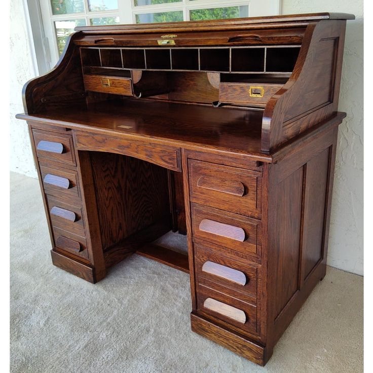 an old fashioned wooden desk with drawers