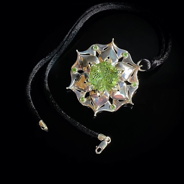 This handcrafted one-of-a-kind pendant features a green glass collector's gem cut by the renowned lapidary artist Dalan Hargrave based in Texas.  The green glass gem is accented by natural tsavorite garnets. It is made from solid 925 sterling silver. I paired this pendant with a black velvet choker with sterling silver clasps, comfortable for daily wear or special occasions. Unique Peridot Jewelry For May Birthstone, Unique Round Peridot Jewelry, Unique Peridot Jewelry, Green Peridot Jewelry For Gift, Fusion Style Emerald Jewelry Gift, Fusion Style Emerald Jewelry For Gifts, Luxury Green Cabochon Necklace, Fusion Style Emerald Jewelry As A Gift, Luxury Peridot Jewelry For Gifts