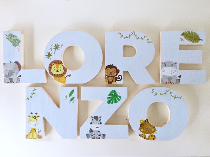 the letters are made out of wood and have animals on them, including zebras