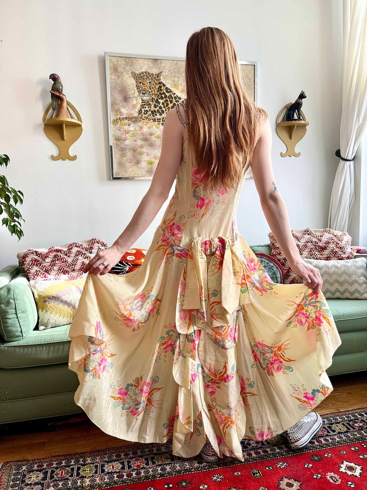 "This is a stunning dress--I've never seen another like it!  Item details: -Silk moiré fabric  -floral print  -pear shaped rhinestone straps  -drop waist  -bow and cascading ruffle at back Measurements:  bust: 36\"  waist: 30\" drop waist: 34\" hip: free Condition: Excellent vintage condition. Slight repair on one strap, covered by rhinestones." Fitted Sleeveless Silk Dress With Floral Print, Summer Silk Gown With Fitted Bodice, Spring Silk Gown For Garden Party, Summer Gown With Floral Print And Fitted Bodice, Summer Silk Gown With Ruffles, Silk Maxi Dress With Fitted Bodice And Floral Print, Silk Maxi Dress With Floral Print And Fitted Bodice, Sleeveless Silk Dress With Floral Print, Silk Floral Print Long Gown