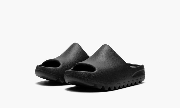 The adidas Yeezy Slide Kids “Onyx” is the kids sizing of the monochromatic black colorway of the popular slip-on sandal by Kanye West.  The “Onyx” was released in March 2022 and is a casual footwear style for the summer and beyond, and a shoe that can easily be worn with anything.  Its lightweight, one-piece EVA foam body is designed in Onyx, or black.  Underneath the sandal, ridges on the outsole provide stability and traction on slippery surfaces.  Release date: March 7, 2022 Adidas Yeezy Slide, Adidas Models, Yeezy Slides, Casual Footwear, Slides Sandals, Stadium Goods, March 7, Slipper Shoes, Adidas Yeezy