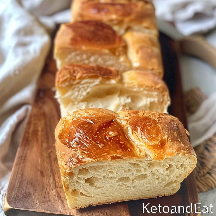 a loaf of bread sitting on top of a wooden cutting board