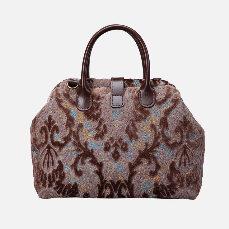 With a nod to the Victorian era, MCW’s freshly combines the classic and elegant design of the traditional carpet bag with a textural and tactile twist.The main body of purse-sized bags is made with thick chenille carpets. The handles and belts are genuine leather with heavy cotton canvas lining. Six bronze stands at the bottom allow the bag to stand stably. Every bag comes with a detachable and adjustable shoulder strap (55 inches) made from the same chenille as the bag and fixed with high-quali Luxury Brown Hobo Bag With Rolled Handles, Elegant Tapestry Bags With Detachable Handle, Elegant Tapestry Tote Bag, Elegant Tapestry Bag For Daily Use, Brown Tapestry Double Handle Bags, Brown Tapestry Bags With Double Handle, Brown Tapestry Bag With Top Carry Handle, Brown Tapestry Shoulder Bag With Double Handle, Brown Tapestry Bags With Handles