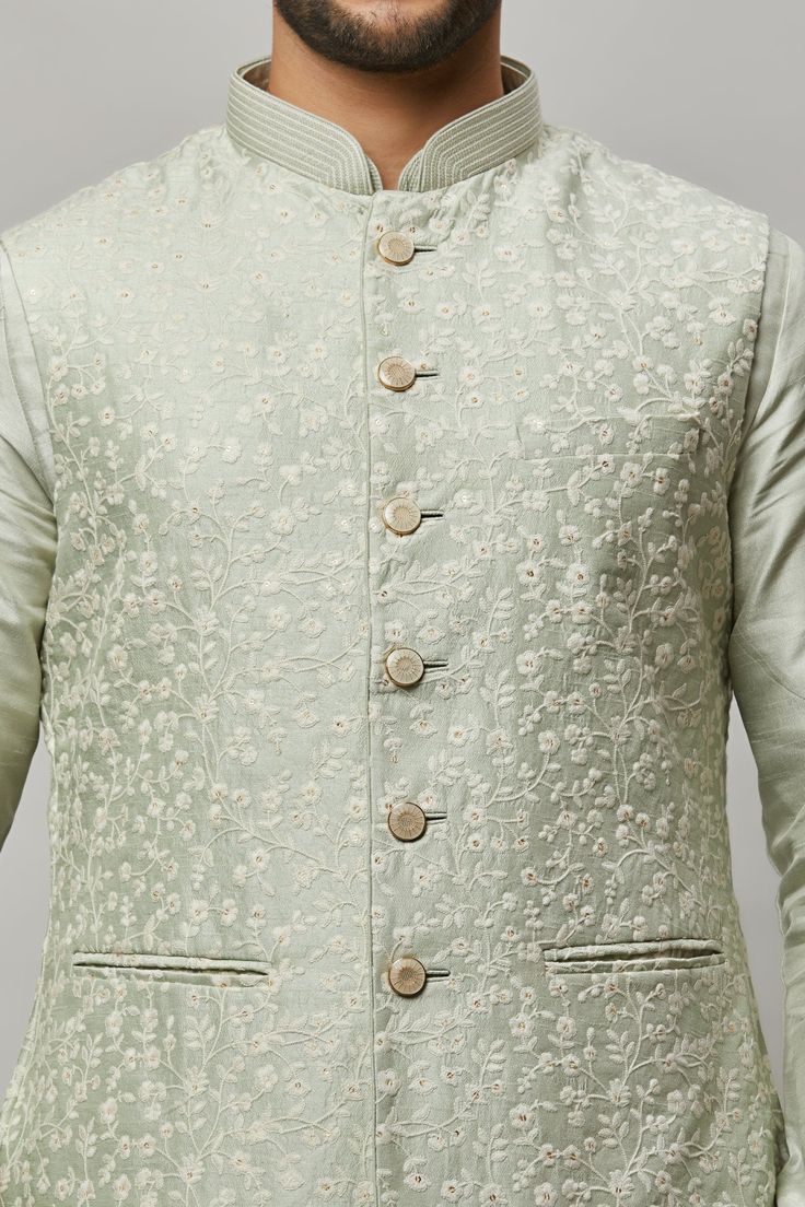 Cotton Linen blended kurta with floral ivory thread & gold sequence intertwined embroidered vest plus ivory churidar. The cotton-linen blend makes it one of our lightest and most breathable kurtas. Crafted with a collar neckline, full sleeves, and front button closure. Occasion: Can be worn to events like Sangeet, Mehendi, & Wedding WASH CARE INSTRUCTIONS - Please Dry clean only when it is applicable. Slight color variation is possible due to digital photography. Spring Chanderi Nehru Jacket With Resham Embroidery, Spring Nehru Jacket With Resham Embroidery In Chanderi, Spring Resham Embroidery Chanderi Nehru Jacket, Cotton Silk Bandhgala With Resham Embroidery For Spring, Spring Cotton Silk Bandhgala With Resham Embroidery, Spring Bandhgala Chanderi Straight Kurta, Spring Chanderi Bandhgala Straight Kurta, Spring Cotton Silk Sherwani With Resham Embroidery, Spring Embroidered Cotton Silk Sherwani