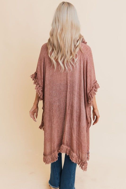 This lightweight, boho chic kimono features stylish fringe and ruffle details, perfect for summer and festivals. Ideal as a casual beach cover-up or a versatile layering piece, it's a trendy addition to any wardrobe. Embrace the bohemian vibe with this fashionable, women's statement kimono. Perfect for those seeking a unique and stylish look. Length: 36.5" Bust Across: 36" Armhole: 11.5" 100% Cotton One Size Fits Most Open Front Can be styled as a wrap top Oversized Bohemian Fall Cover-up, Spring Cotton Tunic Cover-up, Spring Open Front Cotton Cover-up, Breezy Cotton Cover-up For Spring, Chic Cotton Spring Cover-up, Spring Beachwear Cover-up With Fringe, Oversized Bohemian Cover-up For Fall, Spring Beach Cover-up Duster, Free-spirited Spring Festival Cover-up