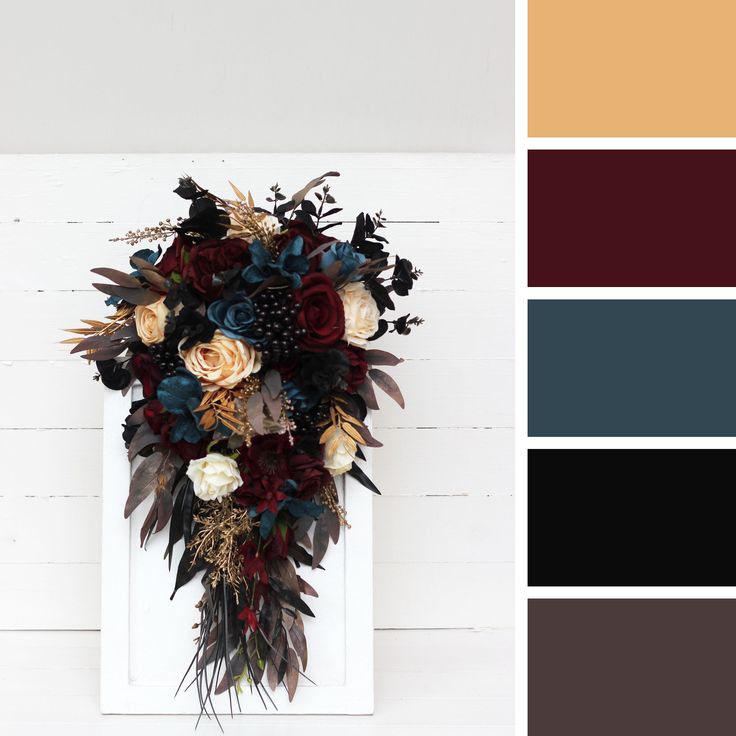 an arrangement of flowers and foliage on a white frame with color swatches in the background