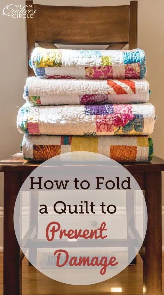 a stack of quilts sitting on top of a table with the words how to fold a quilt to prevent damage