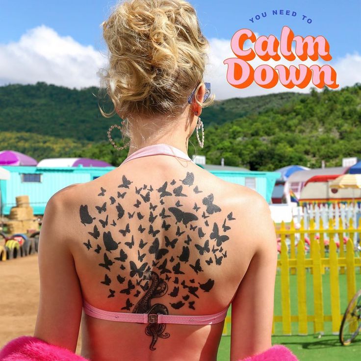 the back of a woman's body with black butterflies on her upper and lower back