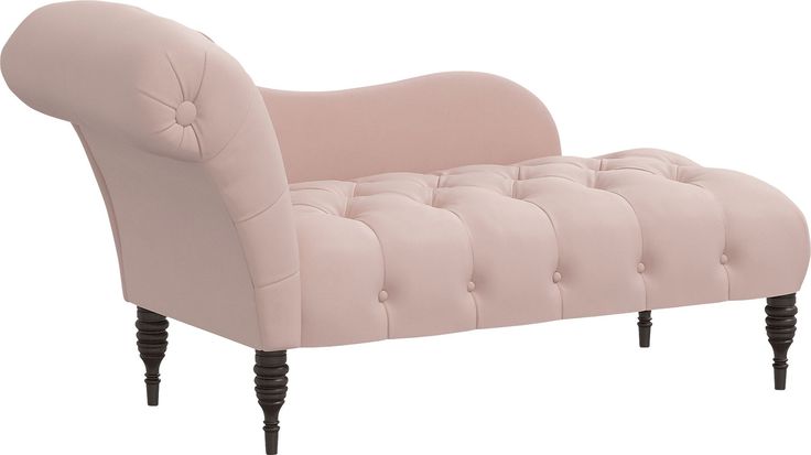 an upholstered pink chair with black legs and buttons on the armrests