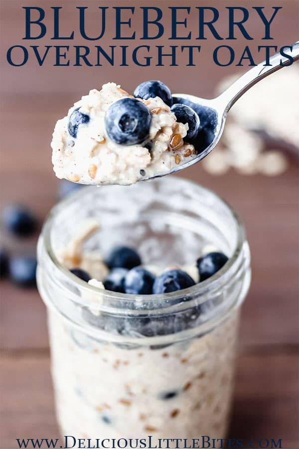 a spoonful of oatmeal with blueberries on it is being held up