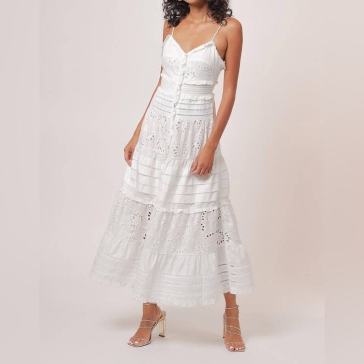 This Line And Lot Pixie Eyelet Maxi Dress In Size M Is A Stunning Addition To Any Wardrobe. The Dress Features A V-Neckline, Button Closure, And Sleeveless Design With Ruffled Trim Accents. It Is Made Of A Blended Fabric Of Polyester And Cotton, And Is Collarless With Eyelet Detailing. Perfect For Casual Occasions In Spring And Summer, This Dress Has A Classic Theme And Solid Pattern. It Is Not Handmade And Has No Character, But It Is A Beautiful Garment With Pleated And Strap Accents. The Dress Sleeveless Eyelet Dress For Spring, Fitted Sleeveless Dress With Broderie Anglaise, Fitted Sleeveless Broderie Anglaise Dress, Sleeveless Broderie Anglaise Dress For Day Out, Sleeveless Fitted Midi Dress With Broderie Anglaise, Fitted Sleeveless Midi Dress With Broderie Anglaise, Sleeveless Eyelet Lace Dress, Sleeveless Lace Eyelet Dress, Feminine Sleeveless Midi Dress With Broderie Anglaise