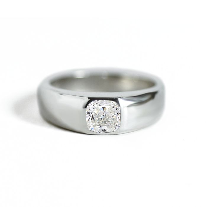 a white gold ring with a single diamond