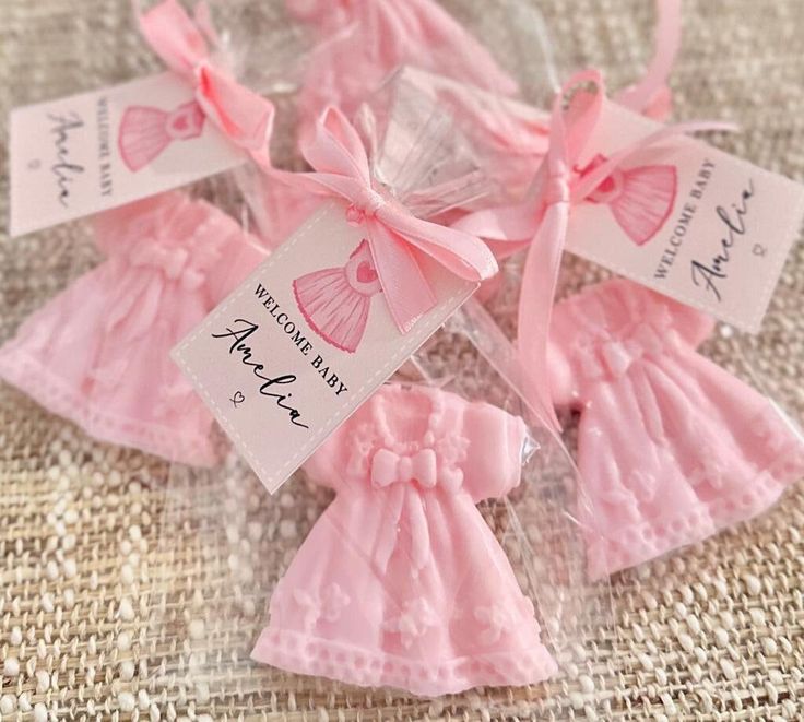 small pink dresses with tags attached to them