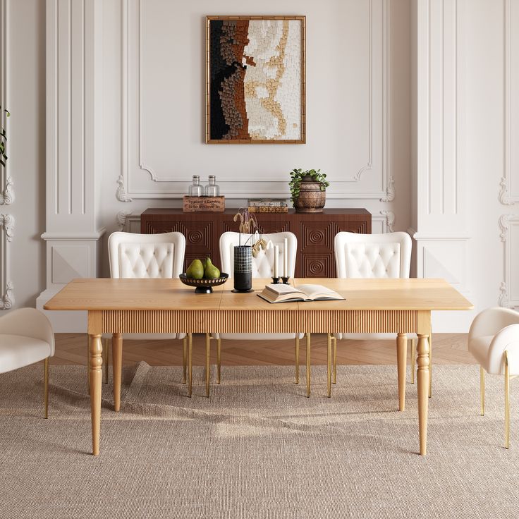 a dining room table with white chairs and an art work on the wall above it