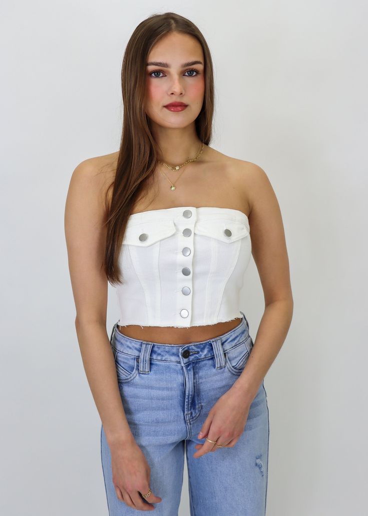 This denim tube top features a cropped fit and front button detailing for the perfect edgy detail! Pair it with your favorite high-waisted shorts or a trendy skirt for a chic look. It will be your go-to piece in your wardrobe and we can't wait to see how you style it! Model Info Meet Christina! Here she is wearing a size small. Hips: 37.5" | Waist: 25.5" | Bust: 33" | Height: 5'6.5" The Details Denim Material Cropped Fit Button Front Detailing 98% Cotton, 2% Spandex Small Hips, Denim Tube Top, Trendy Skirts, Denim Material, Girls Wardrobe, Denim Details, Clothing Essentials, Every Girl, White Denim