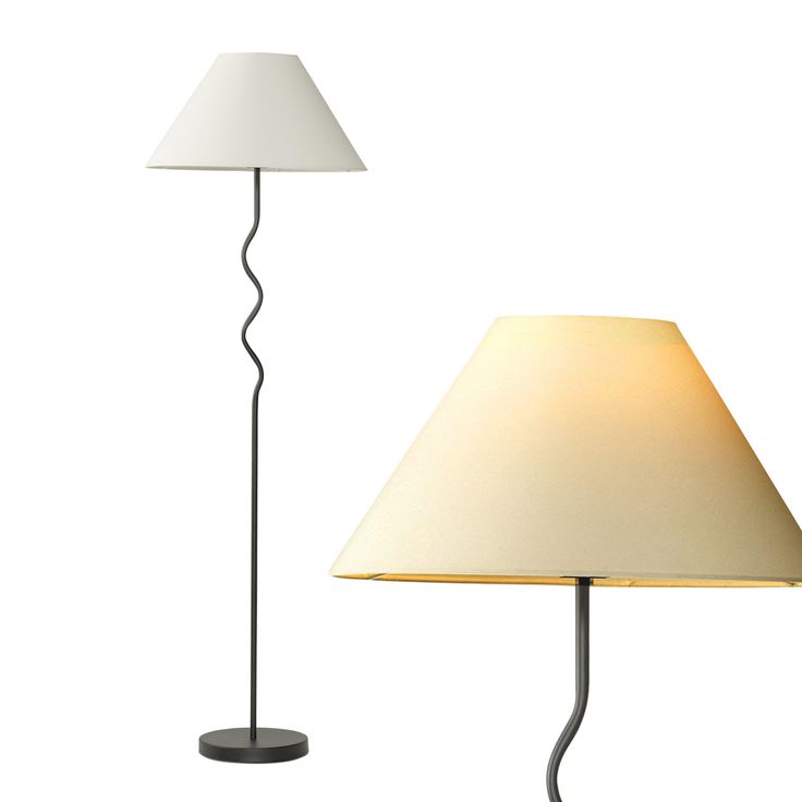 a lamp with a white shade on it and a black base next to the lamp