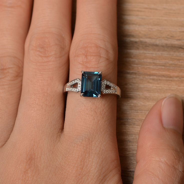 It is a London blue topaz ring. The main stone is 7 mm*9 mm emerald cut.weight about 3.26 carats. The basic metal is sterling silver and plated with rhodium. To change the metal to a solid gold (white/rose) or platinum is also available, please ask for a quotation if you want. You can also go to my shop Home for more elegant rings: https://www.etsy.com/shop/godjewelry?ref=hdr_shop_menu London blue topaz is November birthstone More London blue topaz rings: https://www.etsy.com/shop/godjewelry?ref Elegant Emerald-cut Topaz Rings, Elegant Topaz Rings With Rectangular Stone, Elegant Octagon Topaz Promise Ring, Elegant Rectangular Topaz Promise Ring, Elegant Topaz Ring With Baguette Cut, Classic Emerald-cut Topaz Ring In Sterling Silver, Elegant Baguette Cut Topaz Ring, Rectangular Topaz Ring For Anniversary, Fine Jewelry Topaz Ring With Rectangular Accent Stones