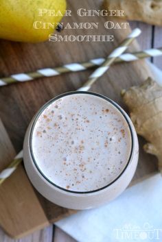 a glass filled with cinnamon oat smoothie on top of a wooden cutting board