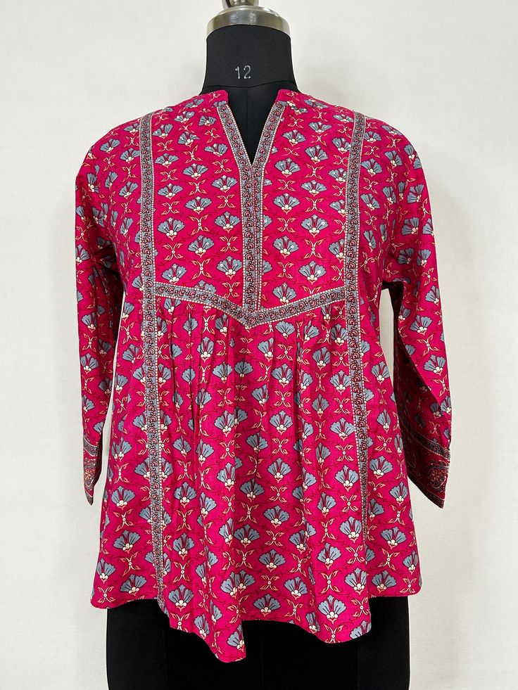 Fuchsia Pink Printed Tunic Top /Kurti For Women Short Kurta For Women- This outfit is made with the finest Pure Cotton of India. The set contains : 1  Kurti Kurti: Fuchsia printed empire top kurti/tunic comes with a mandarin collar neck ,sequinned  details, flared waist and straight hem.  Sleeve length :  3/4 Sleeves   Material : Kurti :  Pure Cotton Fabric Care : Machine wash Front length : 28 inches Please see the photo section  to choose a perfect size for yourself.  *Please note the color of Bohemian Long Sleeve Tops With Printed Motifs, Bohemian Long Sleeve Printed Tops, Multicolor Long Sleeve Tops With Printed Motifs, Traditional Floral Print Tunic Top, Traditional Printed Cotton Tops, Traditional Printed Tops For Festivals, Traditional Long Sleeve Tops With Floral Print, Traditional Pink Block Print Blouse, Casual Pink Tops With Printed Motifs