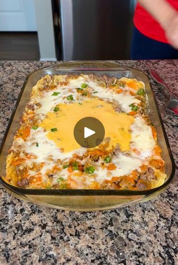 a casserole dish with cheese and meat in it on a granite counter top