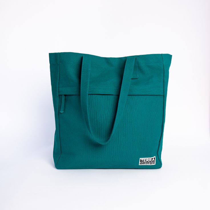 Made with 14 oz heavy duty organic cotton canvas GOTS certified, low impact dyes Lead-free YKK metal zippers Lead-free snap closure 15L capacity, 16"H x 14"W x 4"G Front pocket: 10"H x 14"W Back pockets: H"H x 14"W with divider Made in a Fair Trade Certified Factory Handcrafted in Kolkata, India The Executive Tote is large enough to fit all your office accessories, sturdy enough to stand on its own for easy loading, it’s a snap to open and close, and it’s made with Fairtrade Certified organic co Green Tote Box Bag With Adjustable Strap, Functional Green Tote Bag, Eco-friendly Canvas Tote Bag With Adjustable Strap, Green Eco-friendly Tote Canvas Bag, Eco-friendly Green Tote Shoulder Bag, Tote Bag With Pockets, Work Tote Bag, Small Crossbody Purse, Work Tote