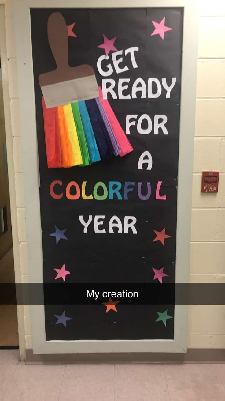 a classroom door decorated with a rainbow paintbrush and the words get ready for a colorful year