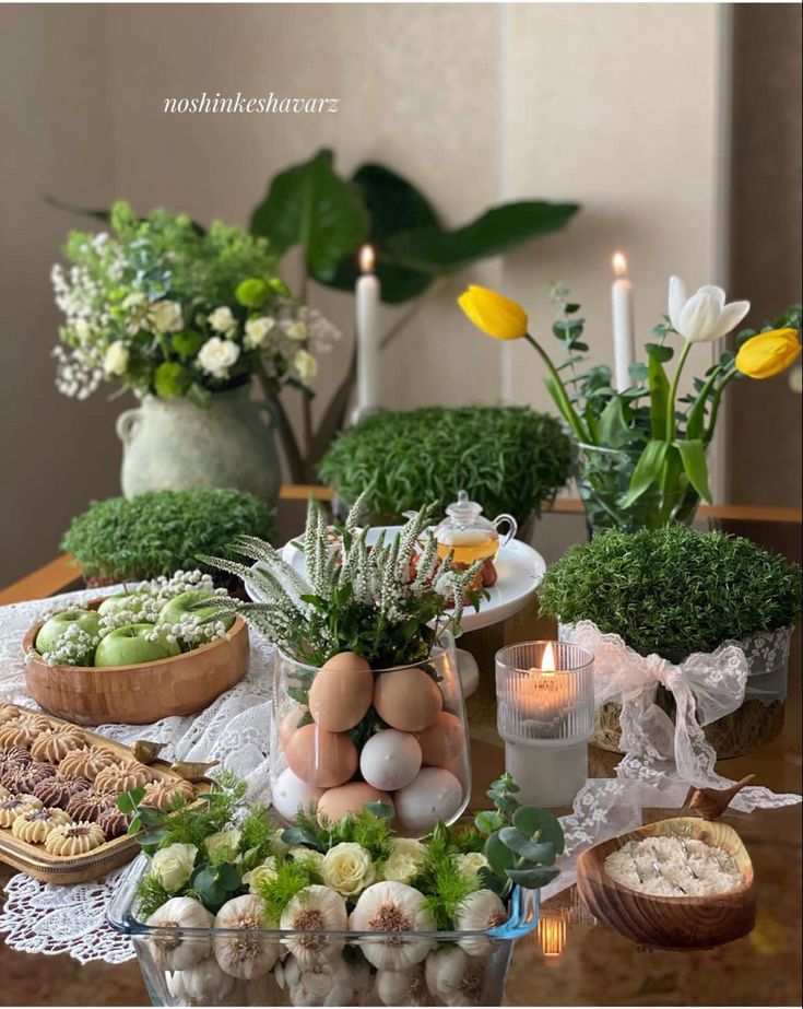 an arrangement of flowers and eggs on a table