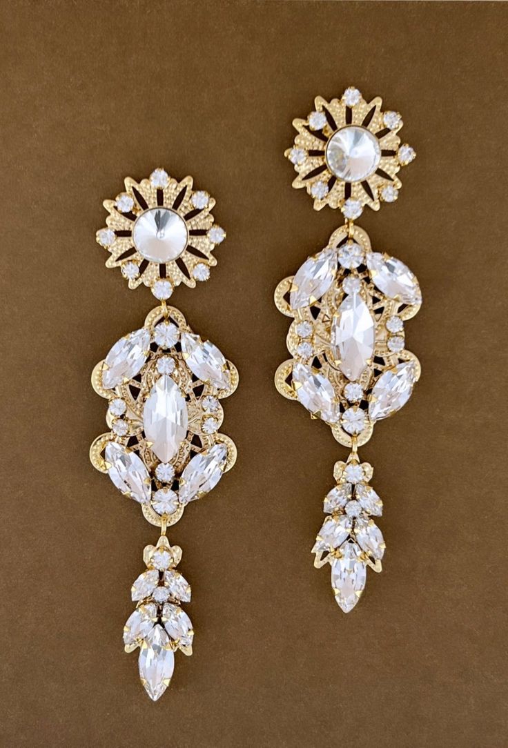 The beautiful MARLEE IKON Earrings with Swarovski and Cubic Zirconia Crystals are Absolutely Precious. They are classic and whimsical to give you that Radiant look that can be worn for any occasion. The design is made up of round crystals with a bold style. They can be styled with most of our wedding headpieces and Bridal Tiaras and Crowns for a gorgeous and statement look. Handcrafted Highest Quality Swarovski / Cubic Zirconia Platinum plated Guards against scratches and tarnish. approximate si Luxury Dual-tone Wedding Earrings, Crystals Wedding, Rose Gold Tiara, Bridal Tiaras, Wedding Headpieces, Pearl Headpiece, Crown Earrings, Gold Headpiece, Gold Tiara