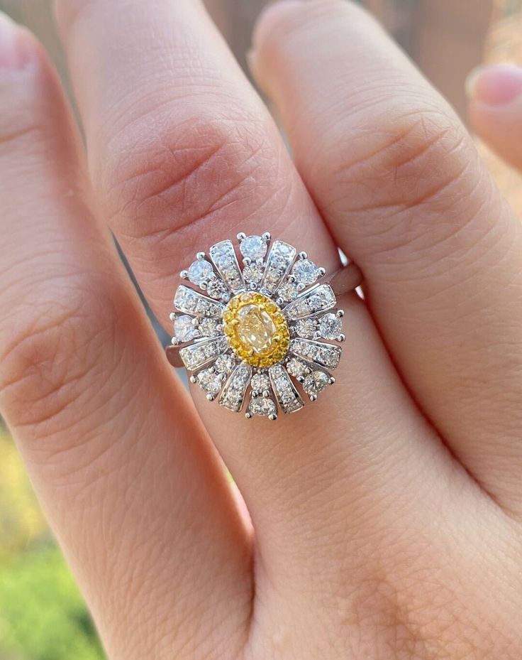 a close up of a person's hand with a ring on it