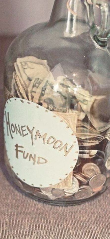 a glass jar filled with money sitting on top of a table