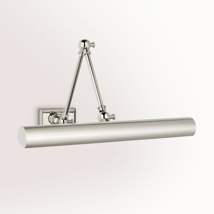 a bathroom light fixture with two lights on each side and one arm hanging from the ceiling