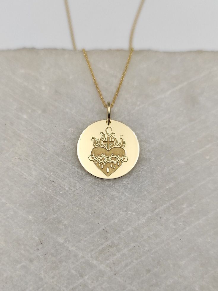 Welcome to RedGiftBox, it is our pleasure providing you our fine gold jewelry! Information about the pendant: - 14K Real Gold - 0.5mm Thick - Jumpring Diameter: 4mm Sizes Available: - 13mm / 0.52 inches - 15mm / 0.59 inches - 18mm / 0.70 inches - 20mm / 0.78 inches - 22mm / 0.86 inches - 24mm / 0.94 inches ▪️ We can engrave the back of your pendant with your custom personalized message, text, name or date for FREE! We recommend 5 lines with a maximum of 15 characters on each line. Information ab Sacred Heart Necklace Gold, Heart-shaped Cadmium-free Jewelry For Gifts, Symbolic Gold Jewelry With Heart Charm, Symbolic Engraved Jewelry For Valentine's Day, Symbolic Heart-shaped Engraved Jewelry, Valentine's Day Symbolic Engraved Jewelry, Symbolic Heart Charm Jewelry For Anniversary, Symbolic Jewelry With Heart Charm For Anniversary, 14k Gold Engraved Heart Necklace For Gift