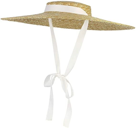 a woman's straw hat with white ribbon tied around the brimmed top