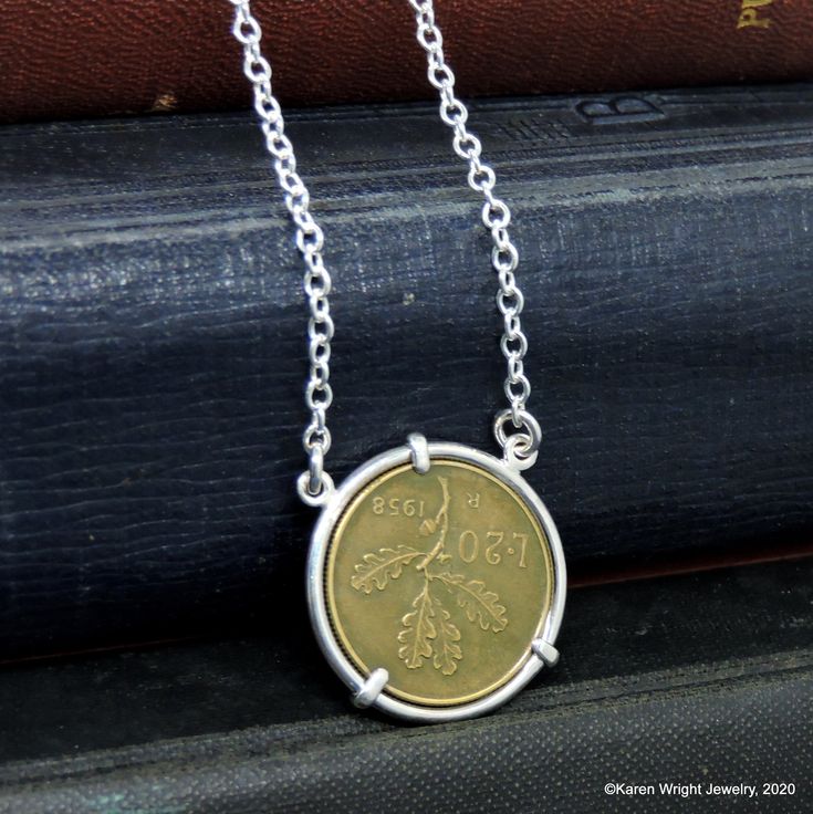 This Italian 20 Lire rests in a handcrafted setting made of recycled sterling silver wire. I make each setting by hand separately from the coin. The coin does not have a hole drilled in it or any metal soldered to its edge. The setting is attached to a sterling silver link chain. Excluding the year on the coin, your coin pendant will look like the pendant pictured. Each coin pendant is made by hand (not a machine), and no two coins are exactly alike. The years that I have in stock are listed. If Handmade Sterling Silver Coin Pendant Necklace, Handmade Sterling Silver Coin Necklace, Handmade Sterling Silver Pendant Coin Necklace, Handmade Coin-shaped Sterling Silver Necklace, Handmade Sterling Silver Medallion Coin Necklace, Handmade Sterling Silver Necklace For Commemoration, Nickel-free Sterling Silver Coin Necklace As Gift, Nickel Free Sterling Silver Coin Necklace Gift, Nickel-free Sterling Silver Coin Necklace For Gift