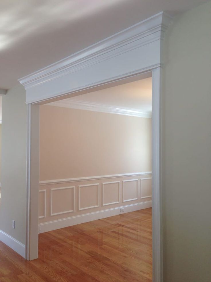 an empty room with hard wood flooring and white trim on the walls, along with hardwood floors