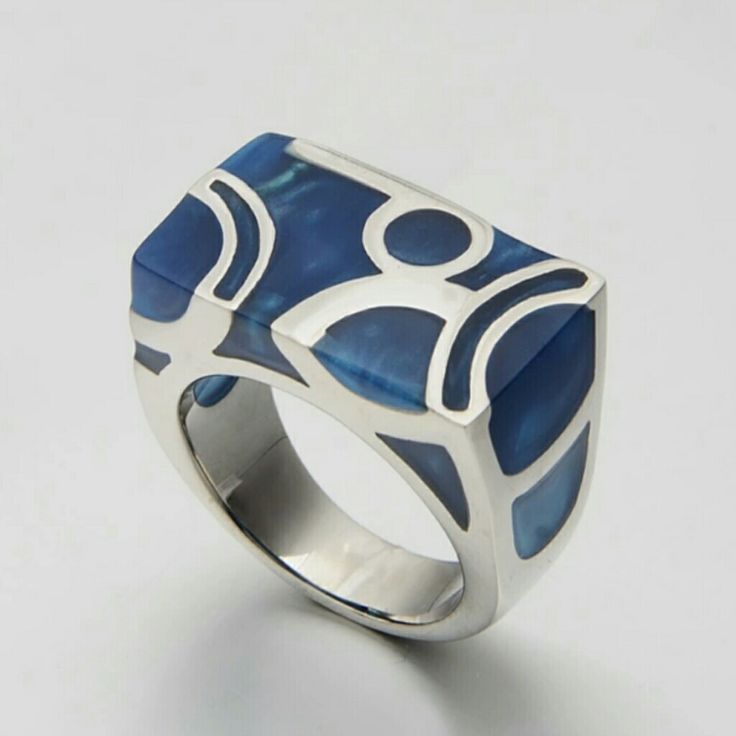 An Absolutely Gorgeous Ring. This Will Surely Turn Heads Heads With It's Beauty. An Elegant Blue With A Unique Look. Stainless Steel So There's No Discoloration On Your Finger. Blue Modernist Jewelry With Polished Finish, Modernist Blue Jewelry With Polished Finish, Blue Metal Jewelry For Anniversary, Modern Blue Ring As Gift, Blue Modernist Jewelry For Gift, Modernist Blue Jewelry For Gift, Modernist Blue Jewelry As Gift, Modernist Blue Jewelry Gift, Modern Blue Metal Jewelry