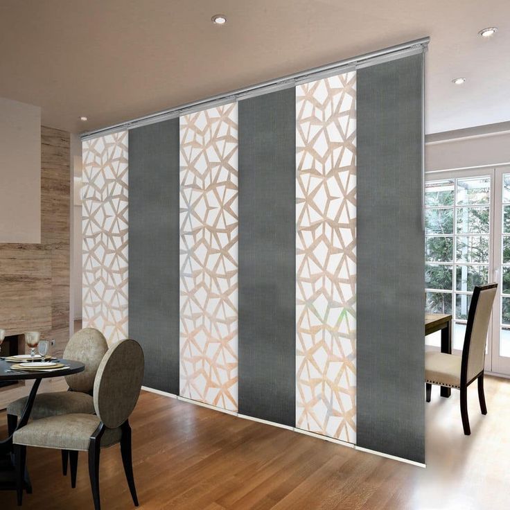 a dining room with wooden floors and sliding glass doors that have decorative designs on them