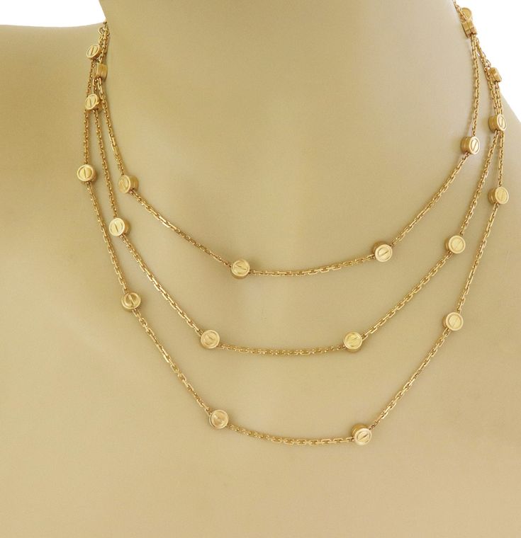 "A classic sophisticated and authentic long necklace by Cartier from the Love Collection. It is crafted from 18k yellow gold with a fine polished finish. The necklace has 30 small round motifs with screw top design on both sides, each is set 1.30 inches apart along the entire length of the oval link chain. The piece fastens with a hook push in long box clasp. It has the designer hallmark serial number and gold content. Brand: Cartier Hallmark: Cartier 750 EO6414 Material: 18k yellow gold Measure Tiffany Earrings, Dot Ring, Jewelry Set Design, Head Ring, Emerald Diamond Ring, Box Clasp, Cartier Love, Gold Band Ring, Wide Band Rings